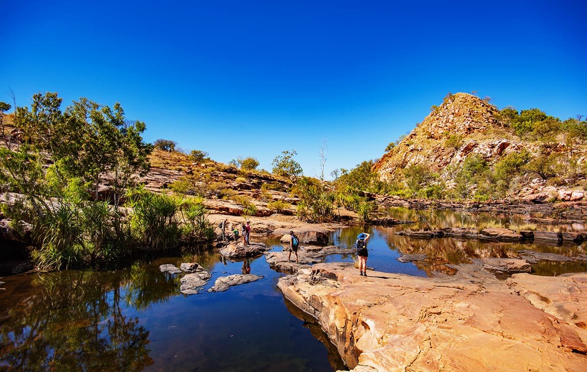 The walk into Bell Gorge, Gibb River Road brings you out above the Bell Falls - You can walk across the river to swim underneath the waterfall