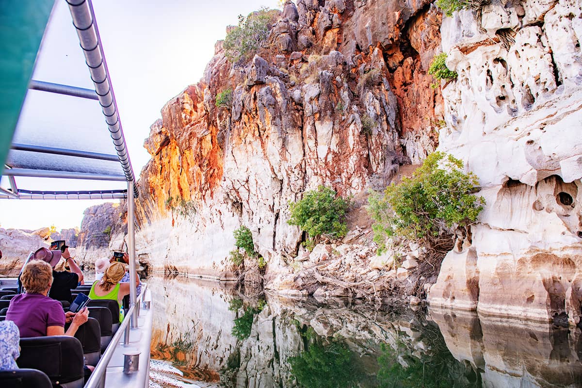 Calm waters of the Fitzroy River create stunning reflections of Danggu, Geike Gorge, an ancient Devonian reef system.