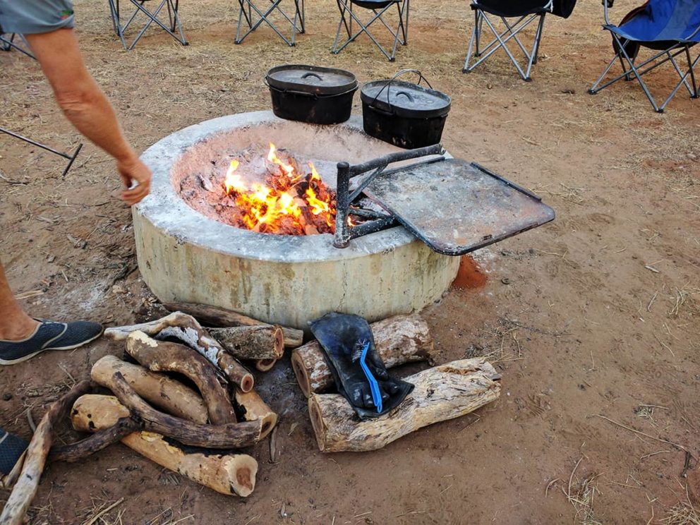 Cast iron camp ovens are used to cook over the coals of a campfire at Windjana Gorge National Park, The Kimberley.