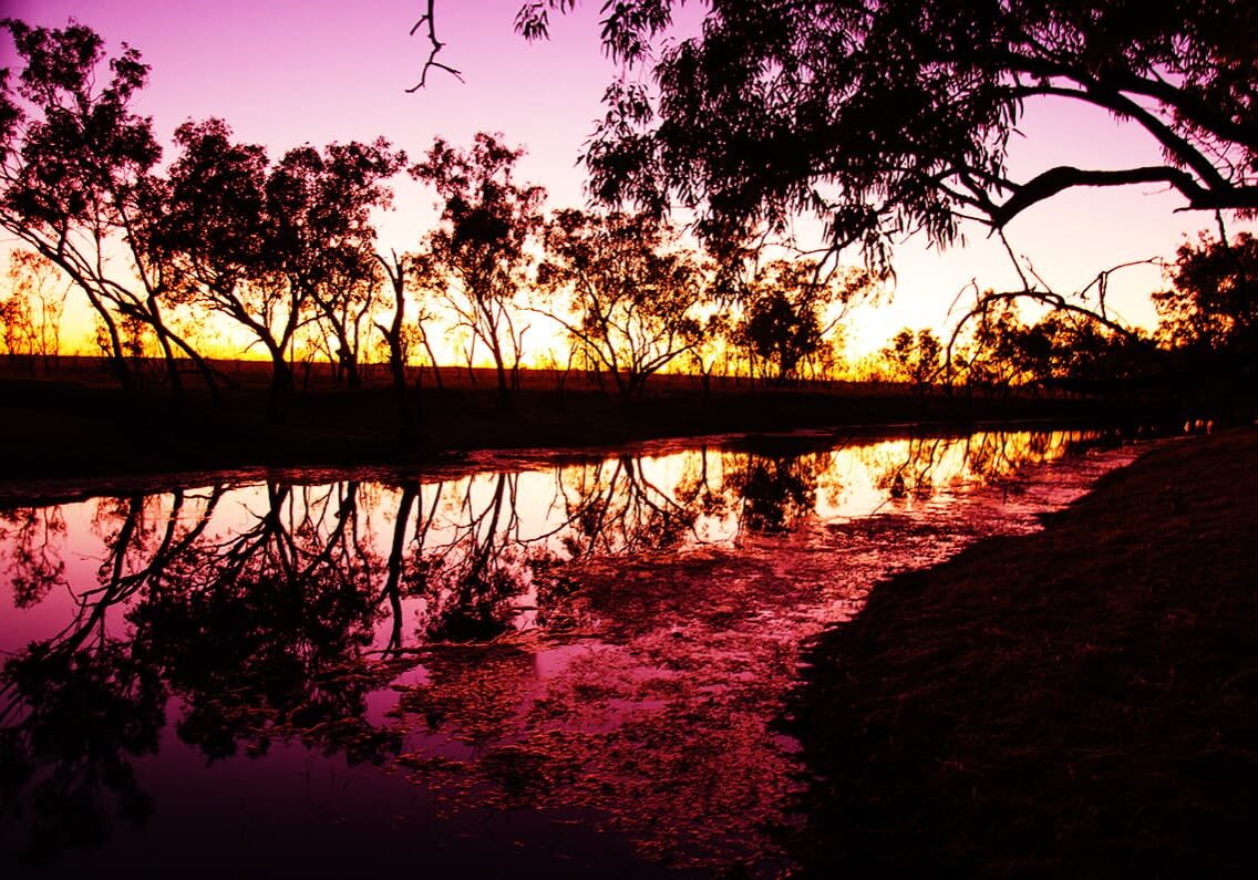Sunset at Adventure Wild's exclusive site, camped by a billabong on a working cattle station in Fitzroy Crossing.